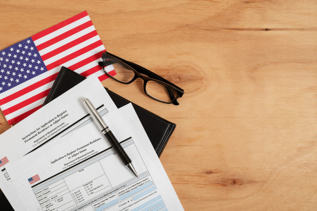 A close-up of legal documents, with a translation certificate and a USCIS form visible.